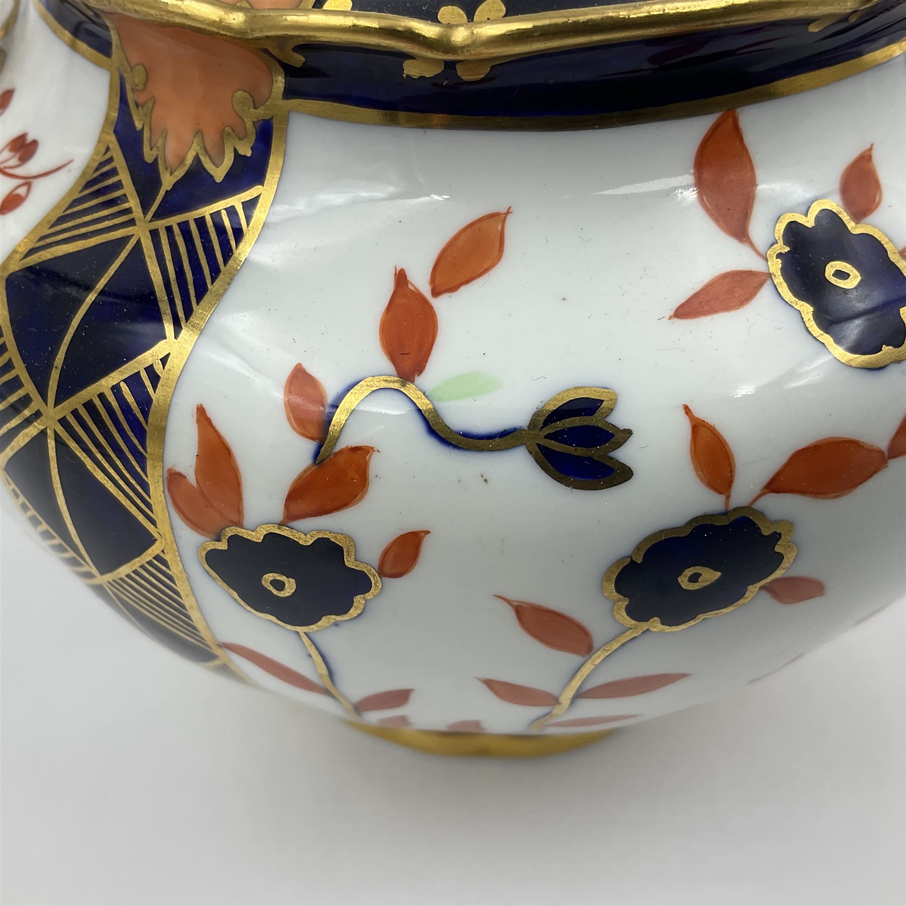 Early 20th century Royal Crown Derby teapot, decorated in a variant of the Imari pattern with blue and red prunus blossoms, with printed mark beneath including illustration date code for 1927, H14cm
