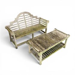 Lutyens design weathered teak garden bench with matching two-tier table, the bench with shaped arched and slatted back over rolled arms and slatted seat