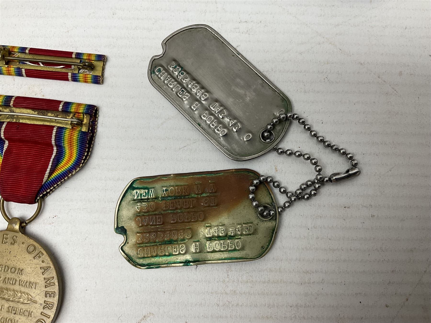 American Purple Heart Medal awarded to 32634848 Charles H. Poppo; cased with identity tags and paperwork; and Bronze Star Medal awarded to U.S. Marine Esteban T. Maranao; cased; American WWII Victory Medal and Asiatic Pacific Campaign Medal