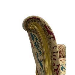 William Bertram & Son of London - pair late 19th century giltwood armchairs, moulded frame with scroll carved back and arm terminals, upholstered in striped fabric with foliate pattern, on shell carved cabriole supports, the brass castors stamped 