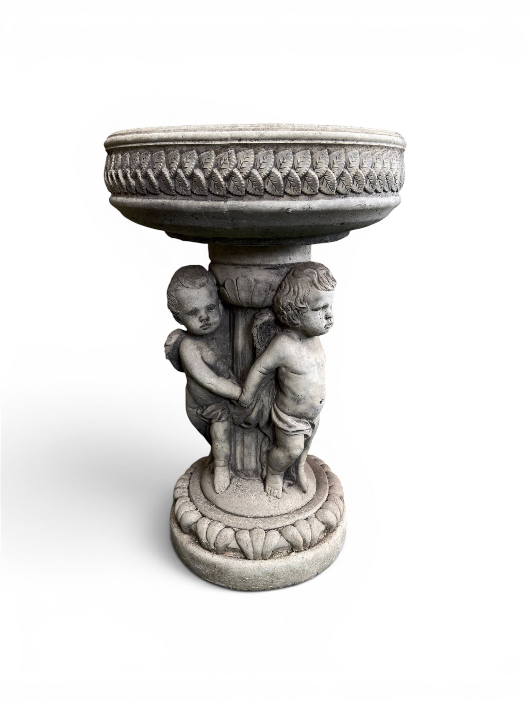 Cast stone cherub bird bath, circular removable top raised on three cherubs with ornate detailing