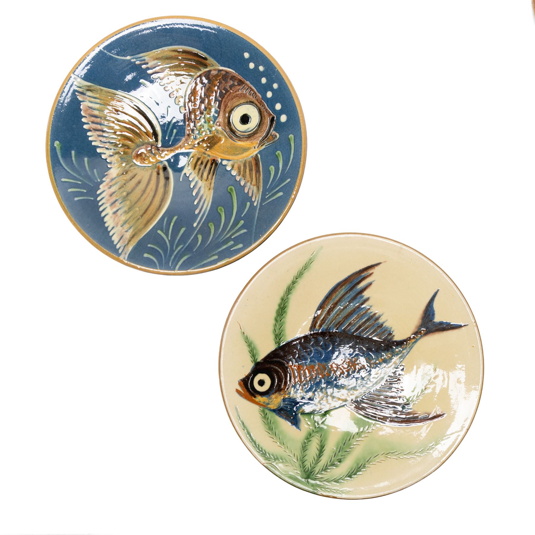 Puigdemont studio pottery slipware chargers, each uniquely decorated with stylised fish, largest D28cm 