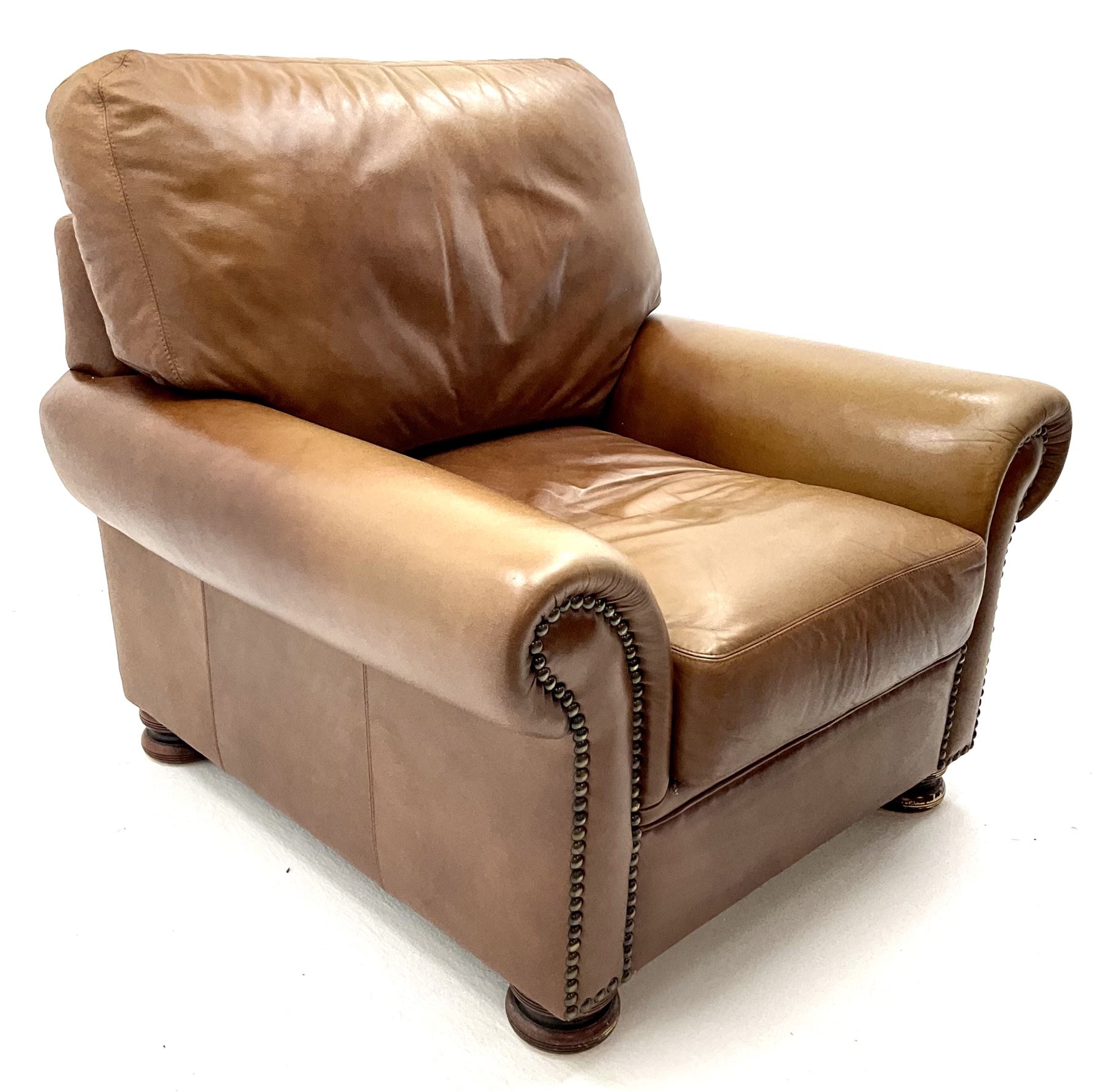 Three seat studded tan leather sofa, scrolling arms, turned supports (W190cm) with matching two seat (W155cm) armchair (W100cm) and footstool 