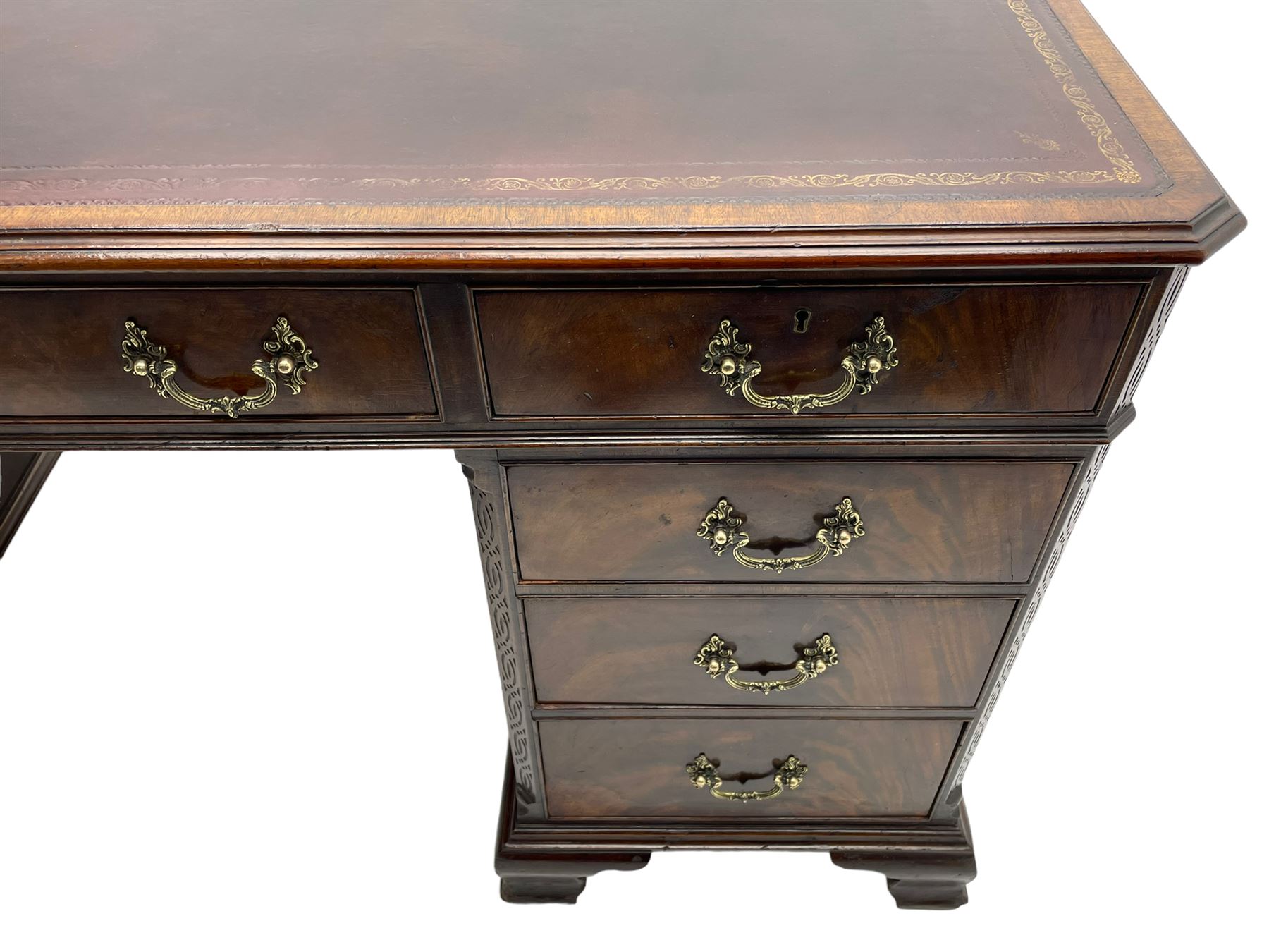 Large Georgian design mahogany twin pedestal partner's desk, moulded rectangular top with canted corners and inset leather writing surface, fitted with nine drawers and two cupboards, the pedestals with canted uprights decorated with blind fretwork, on ogee bracket feet