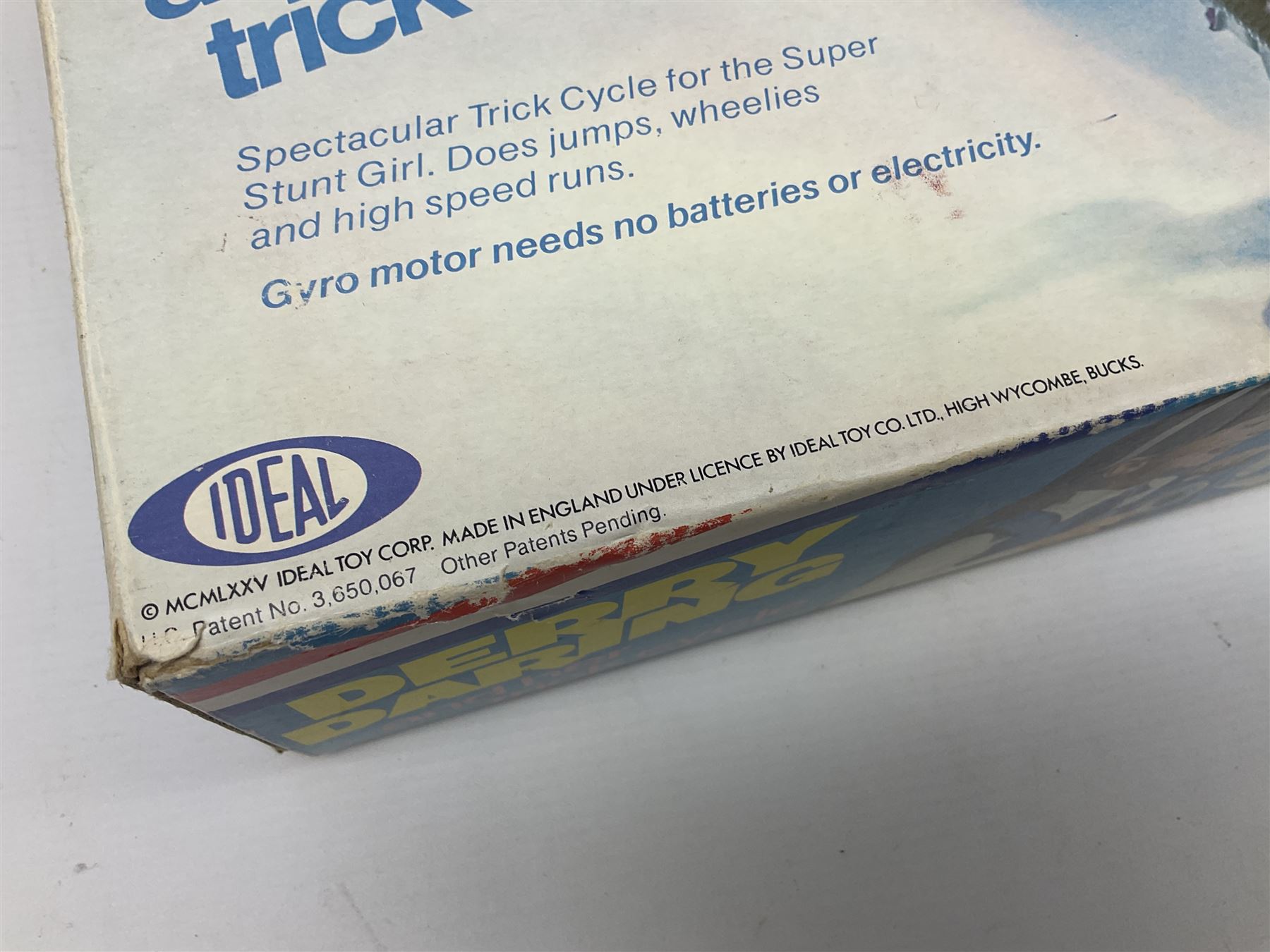 Ideal Derry Daring and Her Trick Cycle, with clothed figure on trick cycle and winder; in original illustrated box dated 1975
