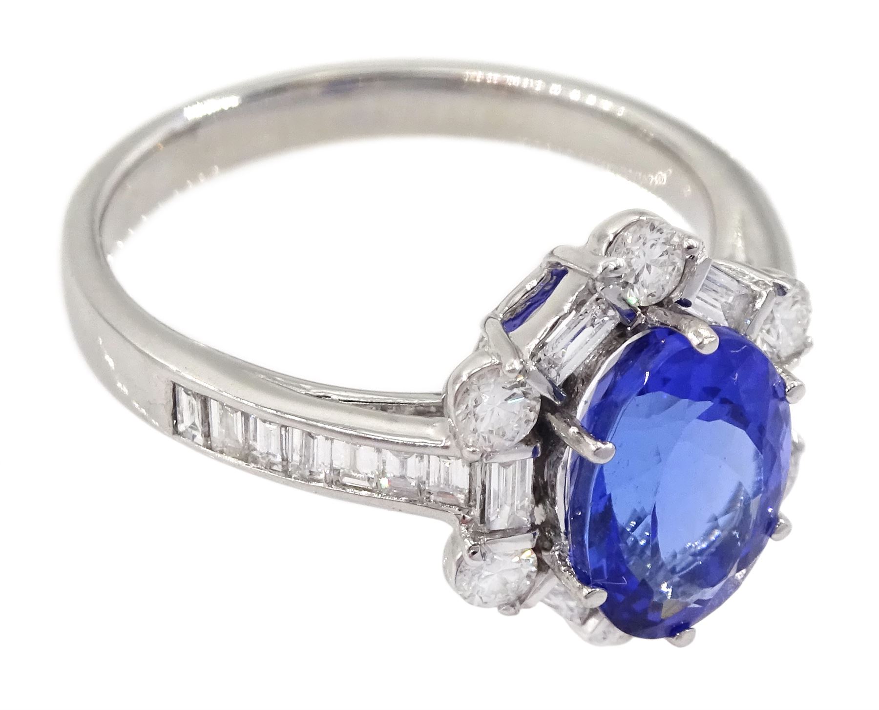 18ct white gold tanzanite and diamond cluster ring, oval tanzanite, with baguette and round brilliant cut diamond surround and baguette cut diamond shoulders, stamped 750, tanzanite approx 1.80 carat, total diamond weight approx 0.55 carat