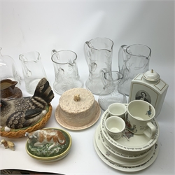 A selection of ceramics and glassware, to include a Victorian pottery butter dish, the lid moulded in the form of a cow, a Sylvac cheese dome with mouse finial, a salt glazed jug, three Scotia figurines, two modelled as cows, the other as a goat, a Copenhagen decanter transfer decorated with a portrait of Sophus Berendsen, eight pieces of Wedwood Peter Rabbit pattern, plus a selection of various glassware, to include two Dartington clear glass decanters, and a number of lemonade jugs. 