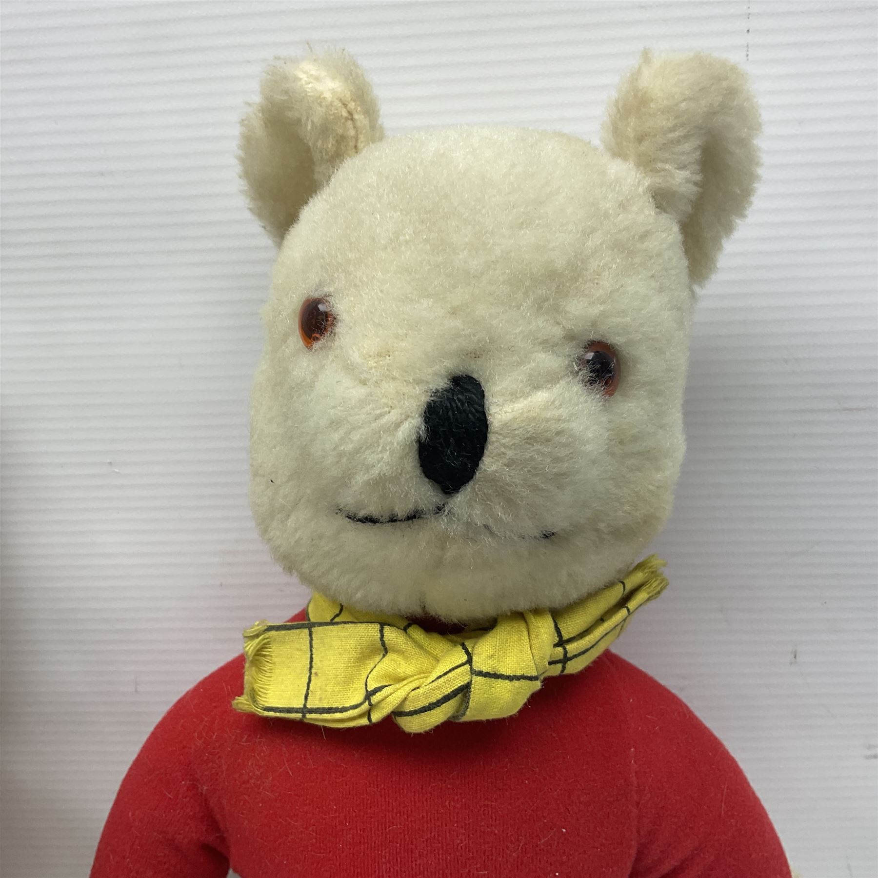 Deans Rag Book Mickey Mouse soft toy, circa 1930's, black velveteen head and body, with cream face and hands, red shorts and yellow felt shoes with leather soles, marked Reg. No. 750811 to neck H20cm; mid-20th century woodwool filled plush covered teddy bear with revolving head, applied eyes, vertically stitched nose and mouth and jointed limbs H52cm; soft toy figure of Rupert Bear; and Japanese clockwork tin-plate and plush covered mechanical toy of a gnome riding a donkey (4)