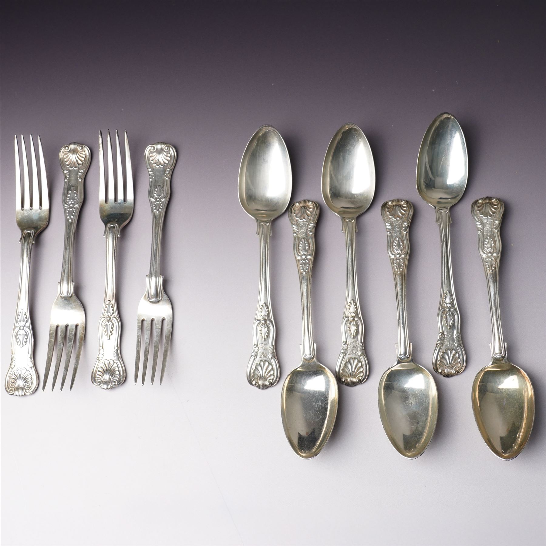 Set of six George IV silver Kings pattern dessert spoons London 1825 Maker Charles Eley  and four 19th century Kings pattern silver dessert forks, various dates