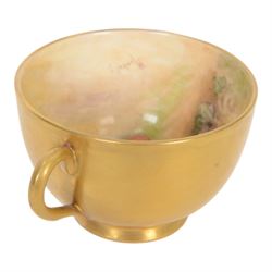 Royal Worcester fruit painted cabinet teacup and saucer, interior hand painted with apples, blackberry and cherries upon a mossy ground, the cup exterior and centre of saucer gilded, cup and saucer signed Rickells, each with puce coloured printed marks beneath, H7cm