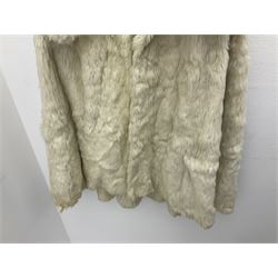 Brown mid length musquash fur coat by National Fur Company together with white rabbit cape
