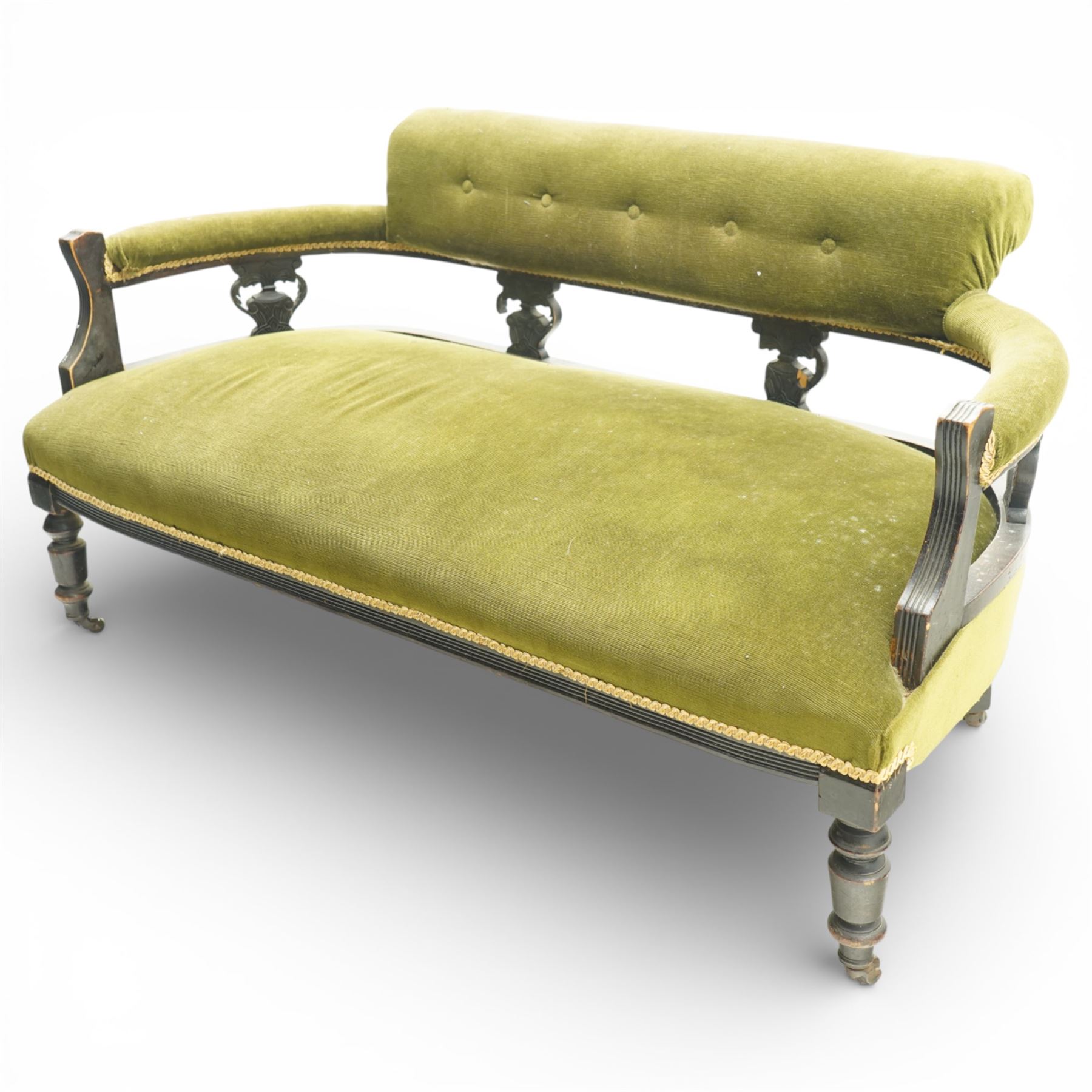 Late 19th century upholstered settee, shaped padded back with a row of button detailing, downswept open arms with upholstered pads, upholstered in olive green velvet, the frame with moulded rails and raised on turned front supports and out-swept rear legs with castors