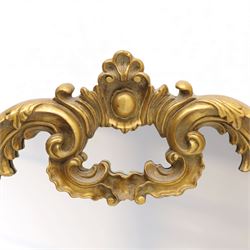 Late 20th century giltwood and composition over mantel mirror, with shaped and scrolled cresting centred by a shell cartouche, with foliate moulded shoulders and lower rail framing a rectangular plate
