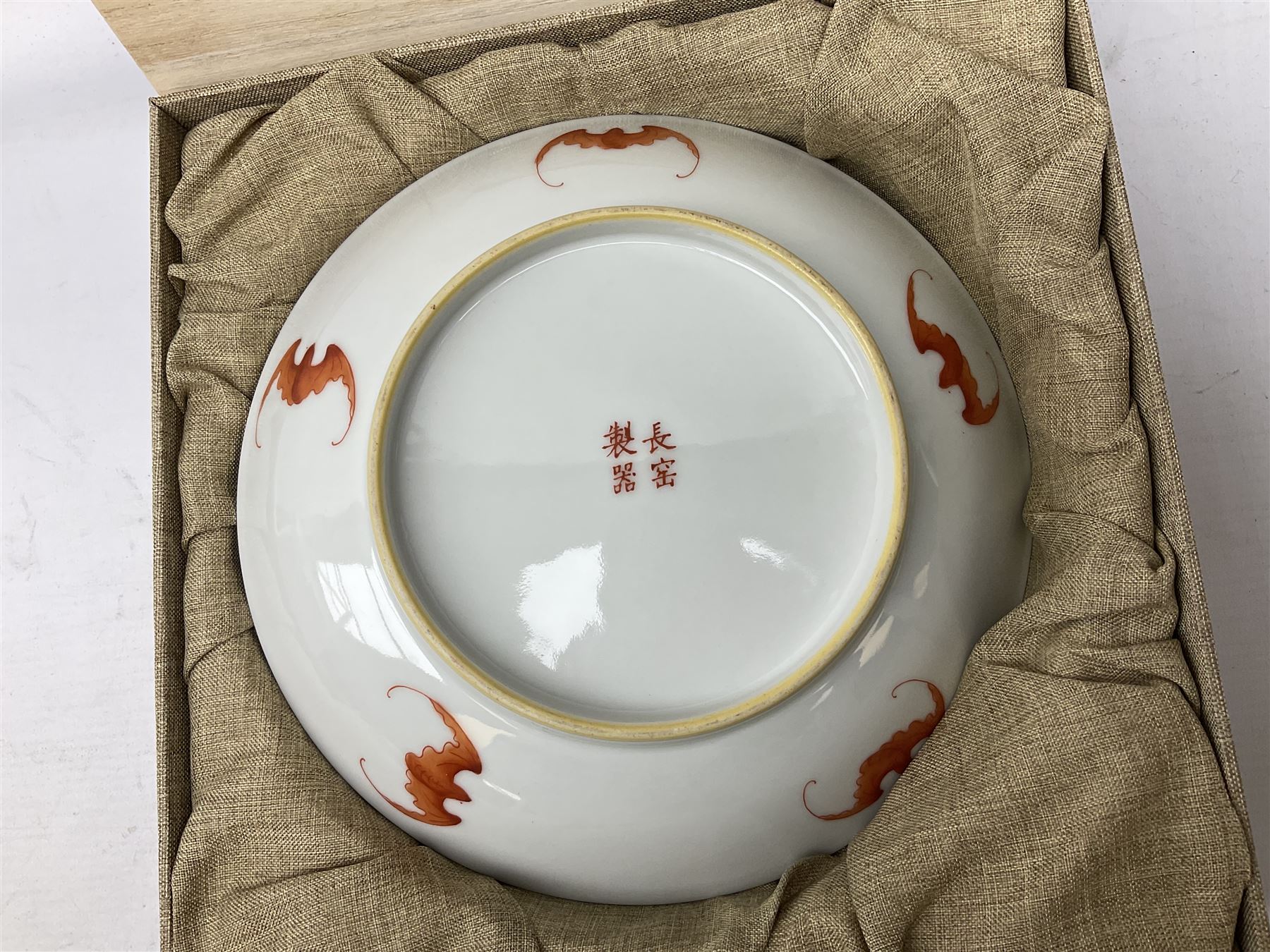 Three Chinese polychrome enamel plates each decorated with floral decoration, all marked beneath, D21cm 