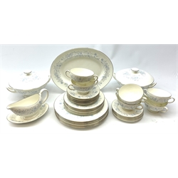 A Wedgwood Belle Fleur pattern dinner service, comprising six dinner plates, six dessert plates, six side plates, six twin handles soup bowls with six saucers, a gravy boat and stand, two tureen and covers and an oval serving platter. 