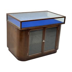 Edwardian inlaid mahogany display cabinet fitted with two glazed cupboards, fitted with rectangular glazed top and sides over a blue velvet interior, twin glazed doors below enclosing a shelved interior on a curved plinth