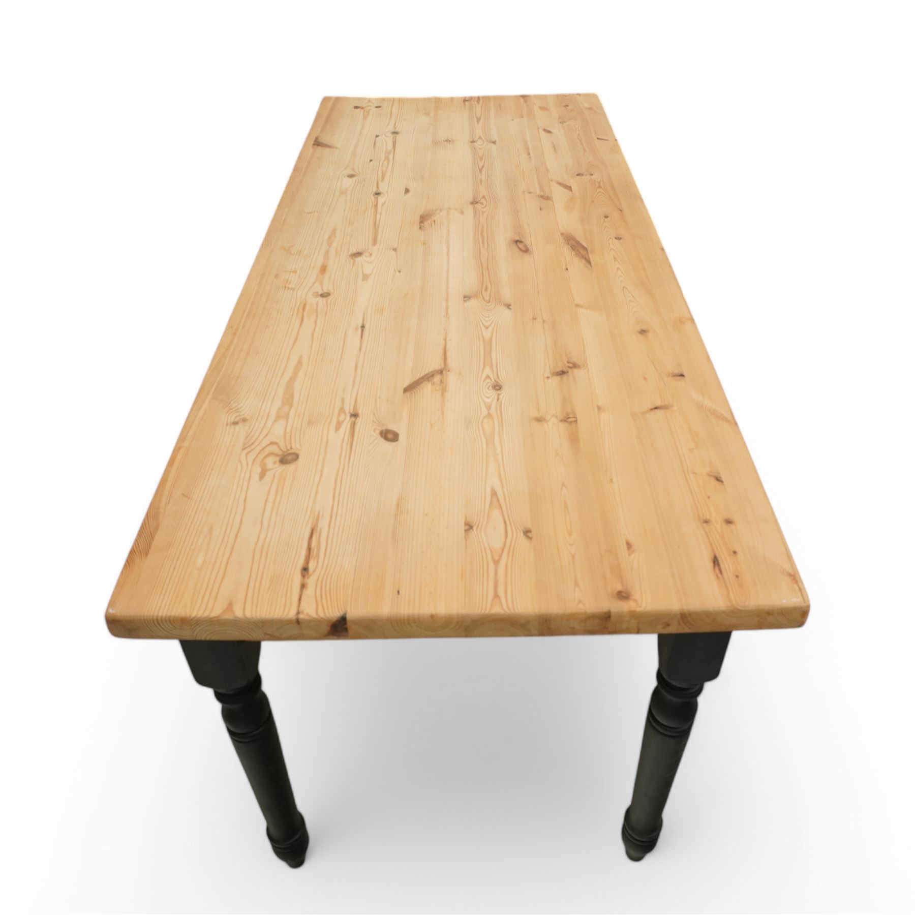 Contemporary country style pine and painted dining table and four chairs, the rectangular plank top with exposed knots and pegged detailing over black painted turned legs, the four Windsor style chairs with shaped seats, spindle splats and turned stretchers, also painted black