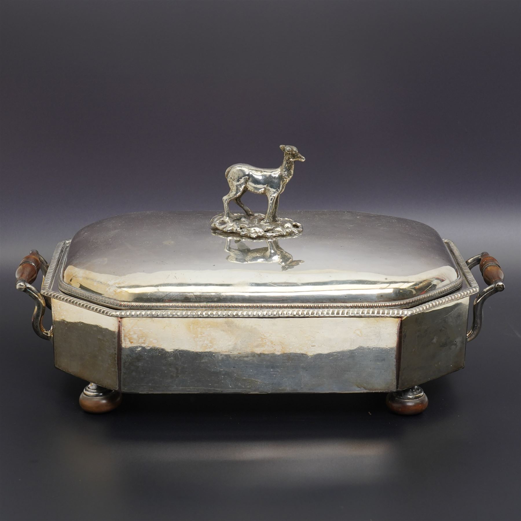 Pair of Georgian design plated candlesticks on square bases H26cm, plated hot water dish, the cover with deer lift and a plated two handled tureen with associated cover