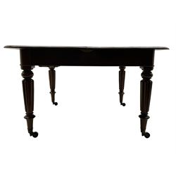 Early 19th century figured mahogany extending dining table, the rectangular top with moulded edge and rounded corners, pull-out action with three additional leaves, raised on turned and lobe carved supports with brass cup castors