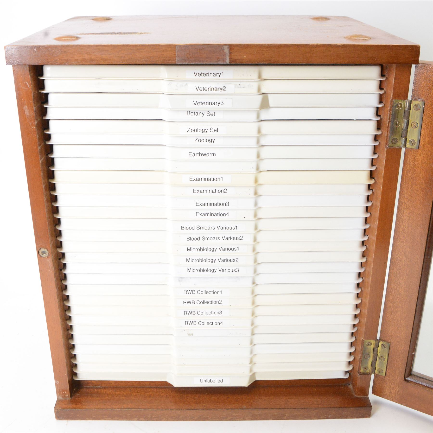 Large collection of prepared microscope slides, including animal and human pathological, physiological and histological specimens and botanical specimens, mostly annotated in ink, with examples including earthworm ovary, pneumonia lung, tip of a human tongue and rabbit cerebellum, contained within two mid 20th century wooden specimen cabinets with glazed doors, each containing twenty-eight plastic slide trays, cabinet H46cm