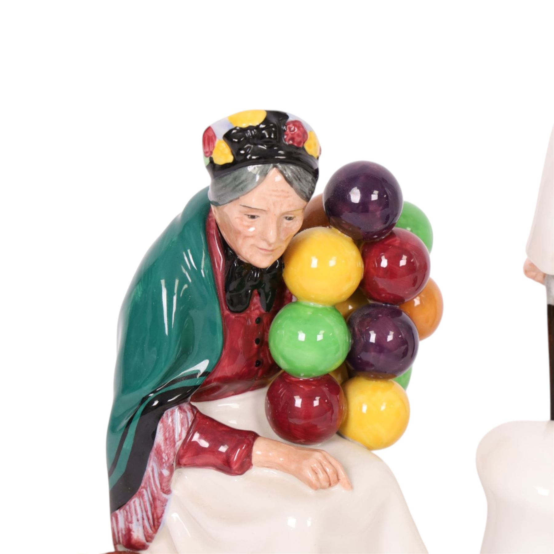 Three Royal Doulton figures, comprising  Churchill HN3057, The Old Balloon Seller HN1315 and The Balloon Man HN 1954