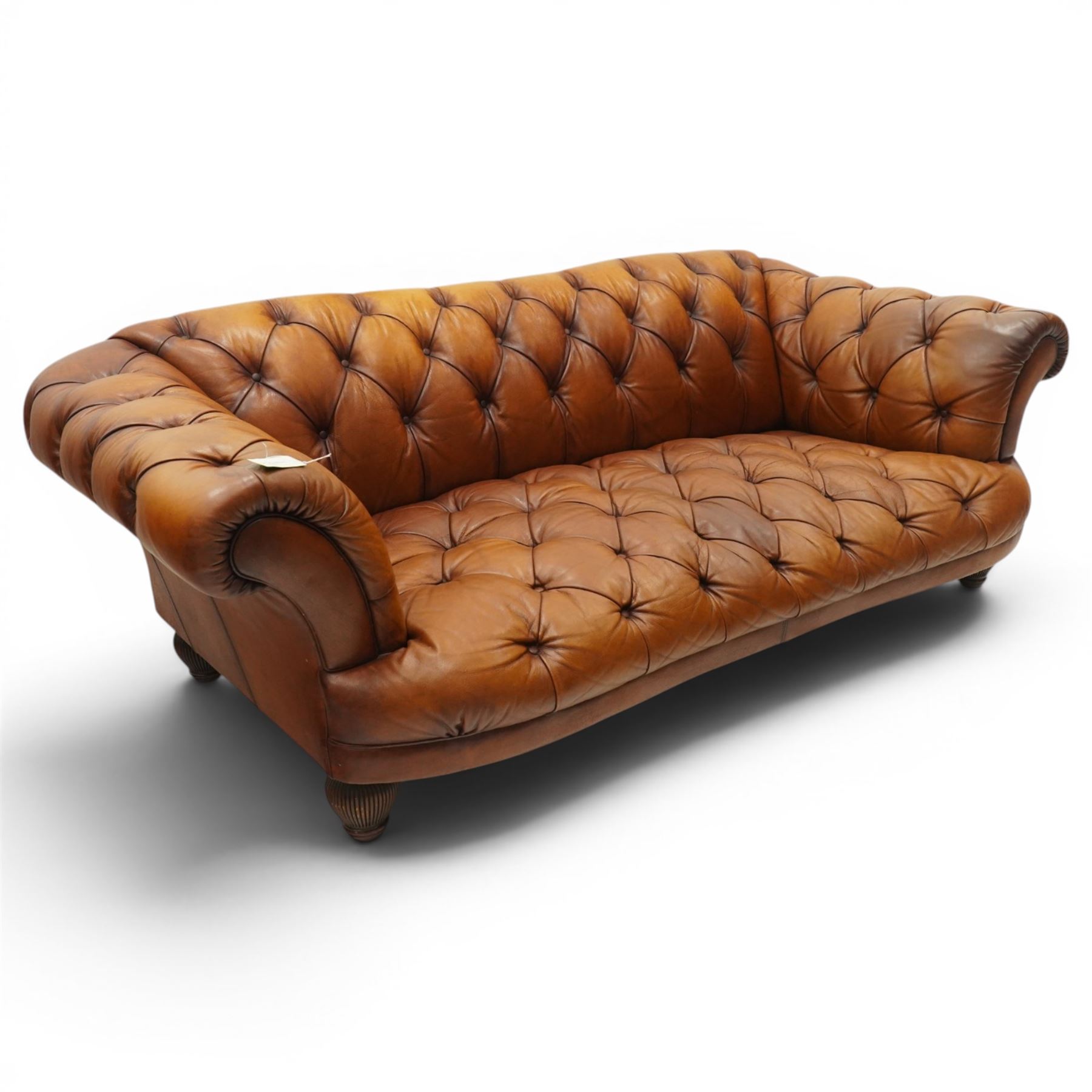 Tetrad - 'Oskar' grande three-seat sofa, Chesterfield shape with rolled arms over serpentine back and front, upholstered in fully buttoned tan leather, raised on reed-moulded feet of globular form