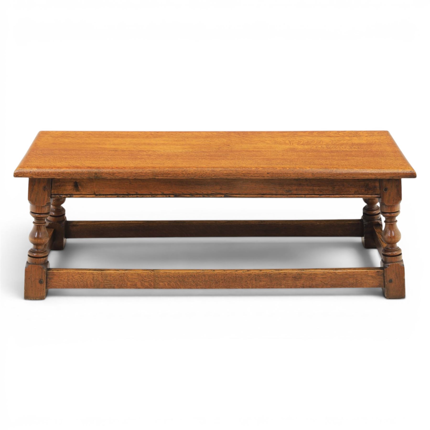 17th century style oak long joint stool, rectangular top with moulded edges, raised on turned supports united by stretchers