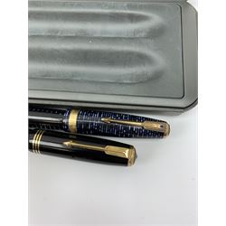Two Parker Vacumatic fountain pens, the first an Azure blue example with gold coloured clip and banding, the second with striated body and nib marked 14K, in associated maker's double recess case. 