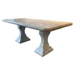 Classical Grecian design Carrera marble centre table, the rectangular single slab top with rounded corners and carved edge, raised on twin pedestals comprised of three pieces with a waisted column on a stepped plinth