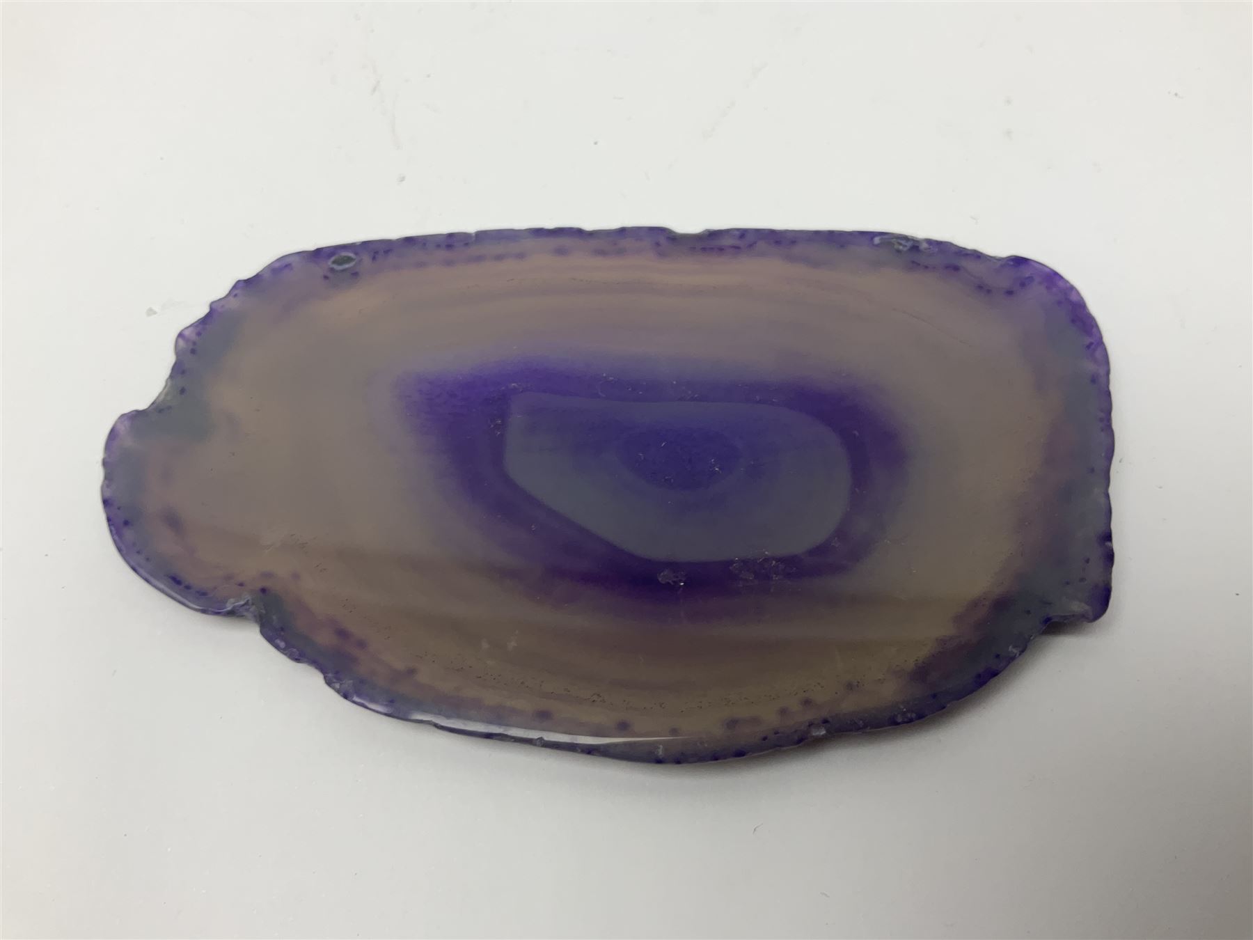 Four purple agate slices of various sizes, polished with rough edges