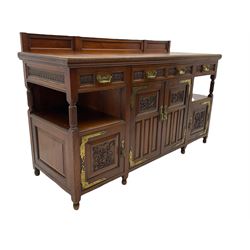 Late 19th century Aesthetic Movement walnut sideboard, fitted with four cupboards and three drawers, brass hinges and handles, carved detail