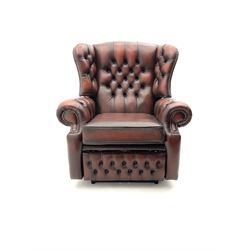 Electric reclining armchair, scrolling arms, upholstered in deep buttoned brown leather