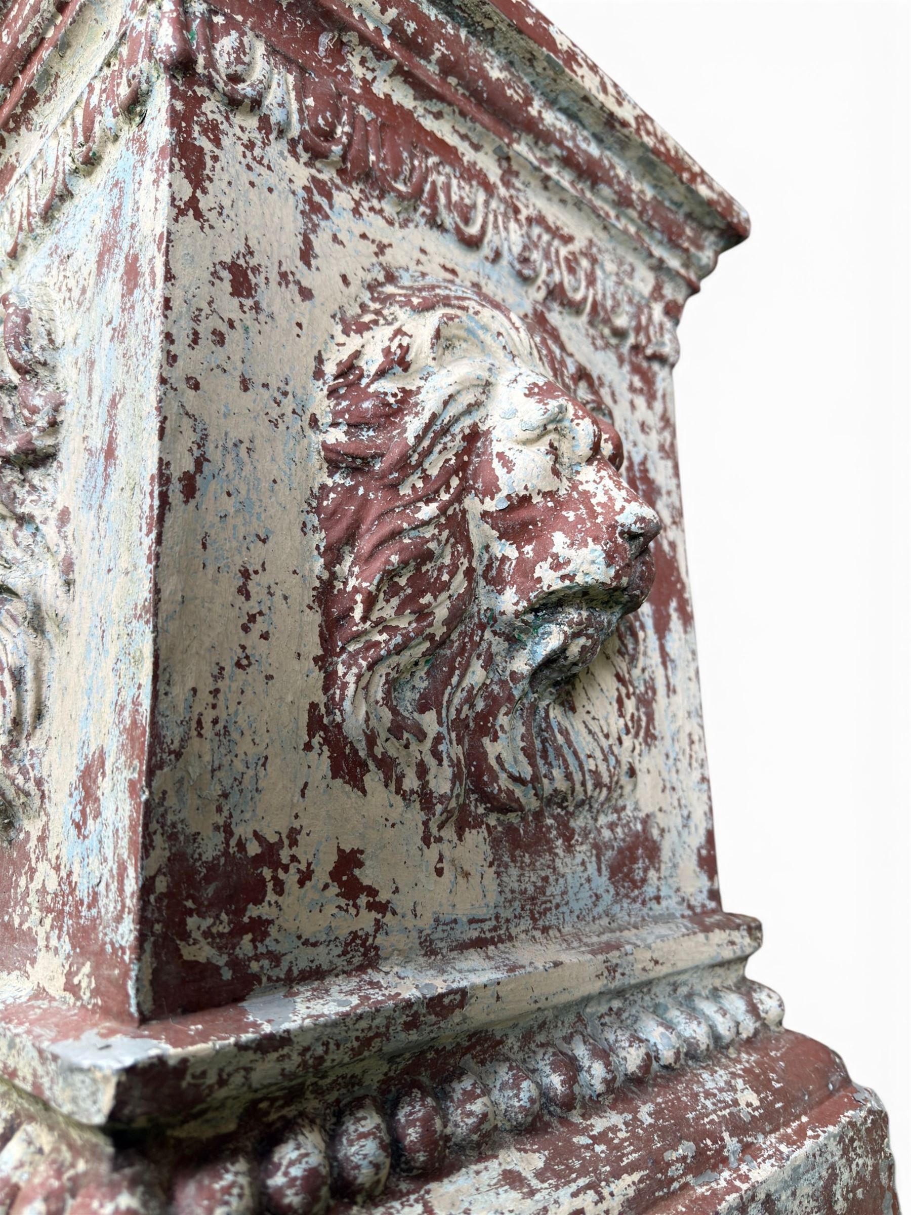 Early 20th century terracotta pedestal, square form with egg and dart detail, four lions masks to either side, finished in distressed cream paint