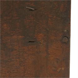 Small 17th century six plank oak coffer, figured top with iron pintle type hinges,  pegged boarded sides, large lock plate with rivets, plank ends continuing down as supports