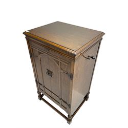 Early 20th century ‘HMV' 202 cabinet gramophone, oak cased, moulded top with foliate carved moulding hinges to reveal gramophone, two doors enclosing horn, on turned supports joined by moulded stretcher rails