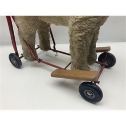 Tri ang - Pedigree Soft Toys - push along/ride-on dog as a wood wool filled plush Airedale terrier in red tubular frame with beech footrests and black rubber wheels; stitched Northern Ireland label in tact L60cm H61cm