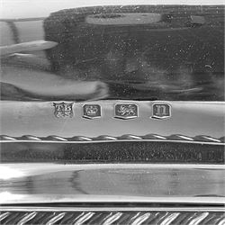 Early 20th century silver entree dish and cover, of rectangular form with shaped corners and oblique gadrooned borders to base and cover, the cover with loop 'bamboo' handle, hallmarked Thomas Bradbury & Sons Ltd, Sheffield 1930, including handle H10.5cm L24.5cm