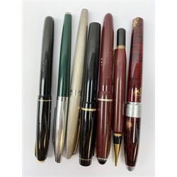A Croxley Dickinson fountain pen, with black resin body, lever fill action and nib marked 14ct, together with two Waterman's pens, comprising a 502 with black resin body, lever fill action and nib marked 14ct, and an Argent Massif with engine turned decoration to body and nib marked 18K, an Osmiroid fountain pen with burgundy resin body and lever fill action, two further fountain pens, and a propelling pencil. (7). 