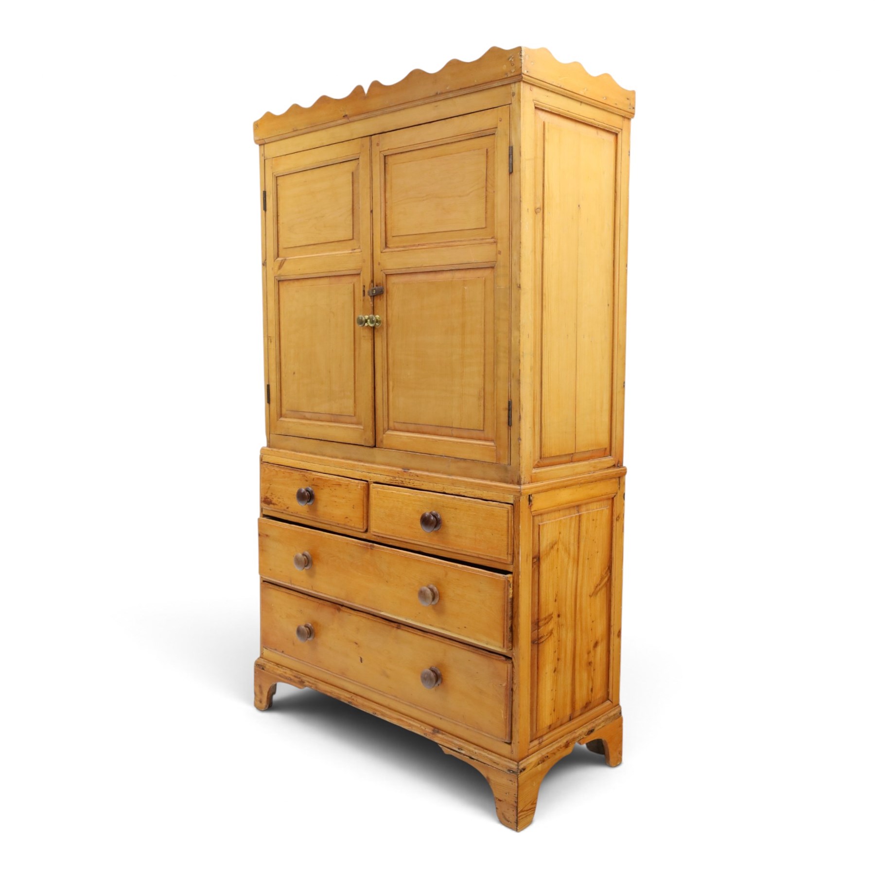 19th century waxed pine press cupboard, shaped cornice above a twin fielded panelled cupboard door enclosing a fixed shelf, the lower section two short two long drawer