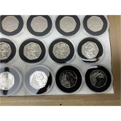 Thirty-seven commemorative fifty pence coins, including 2011 wrestling, other Olympics, Beatrix Potter etc, housed in capsules