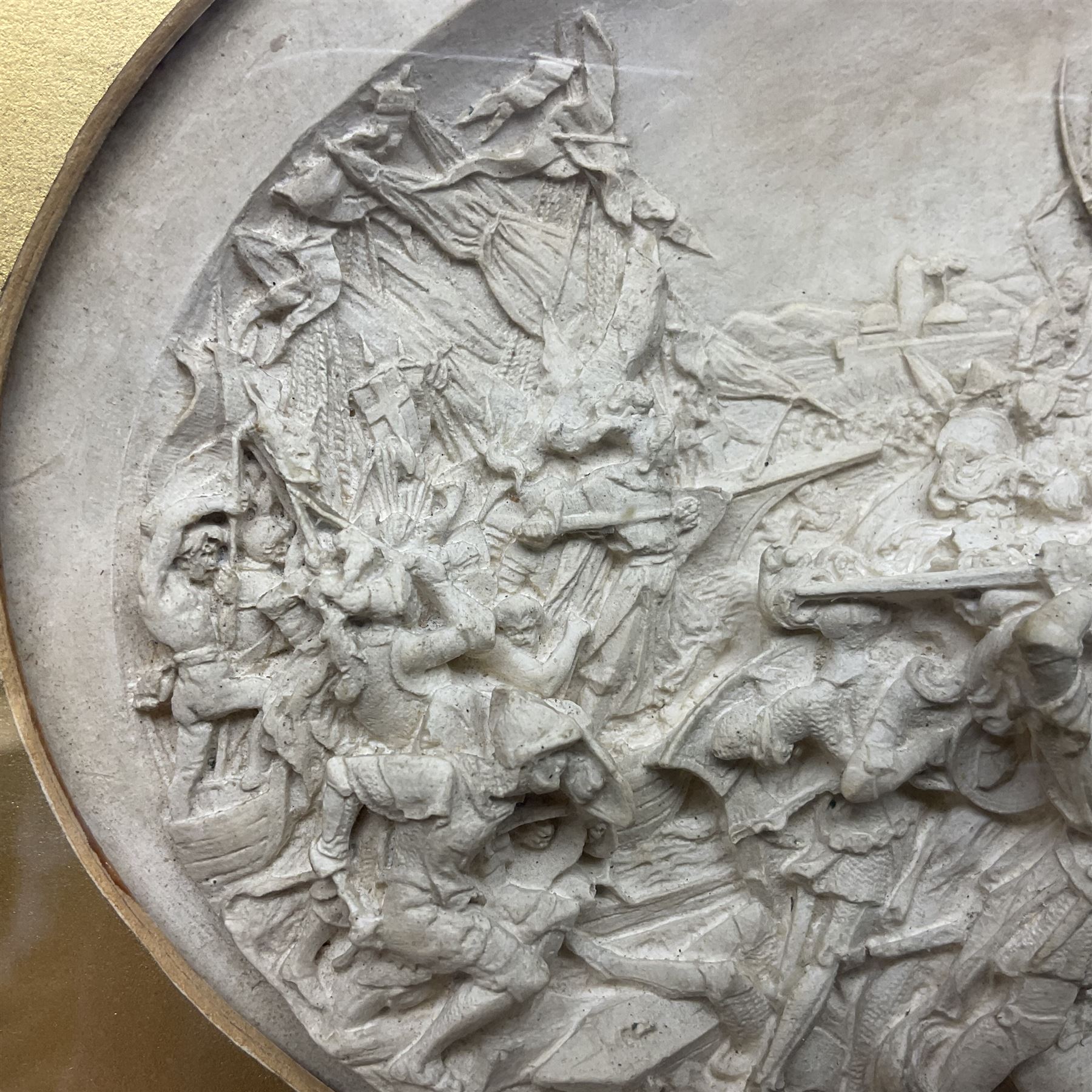 Justin Mathieu, two oval high relief plaque depicting a battle scenes, each within a wooden frame, frame  H21cm, L25cm