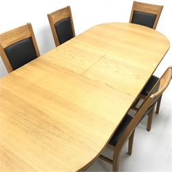 Oval solid oak extending dining table,  two turned columns on shaped supports joined by stretcher (W200cm and 250cm, H68cm, D101cm) and six oak framed chairs, upholstered back and seat (W44cm)