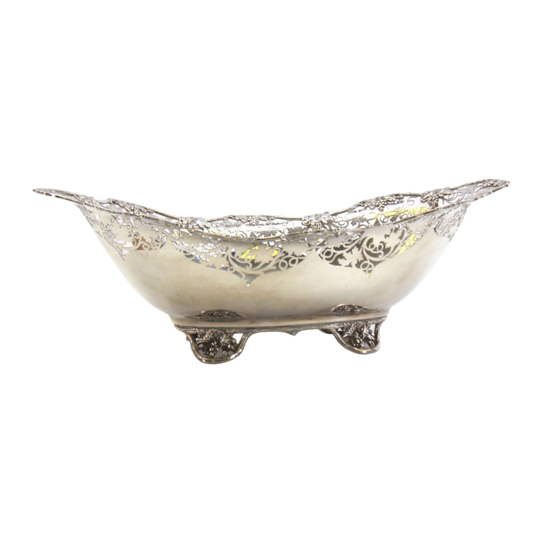 Early 20th century silver bowl, of oval form, the serpentine shaped edge with fruiting vine pierced and applied moulded decoration, upon four conforming fruiting vine feet, hallmarked Manoah Rhodes & Sons Ltd, Sheffield 1931, also bearing impressed mark Manoah Rhodes & Sons Lts Bradford, H11cm L34cm D19cm