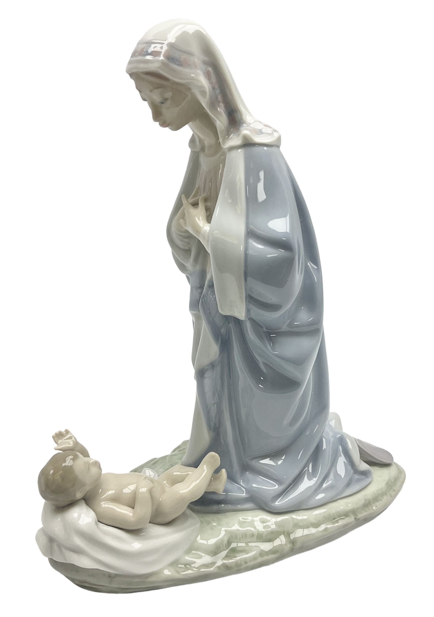 Lladro figure, Holy Night, modelled as Mary kneeling over baby Jesus, sculpted by Vincente Martinez, with original box, no 5796, year issued 1991, year retired 1994, H22cm