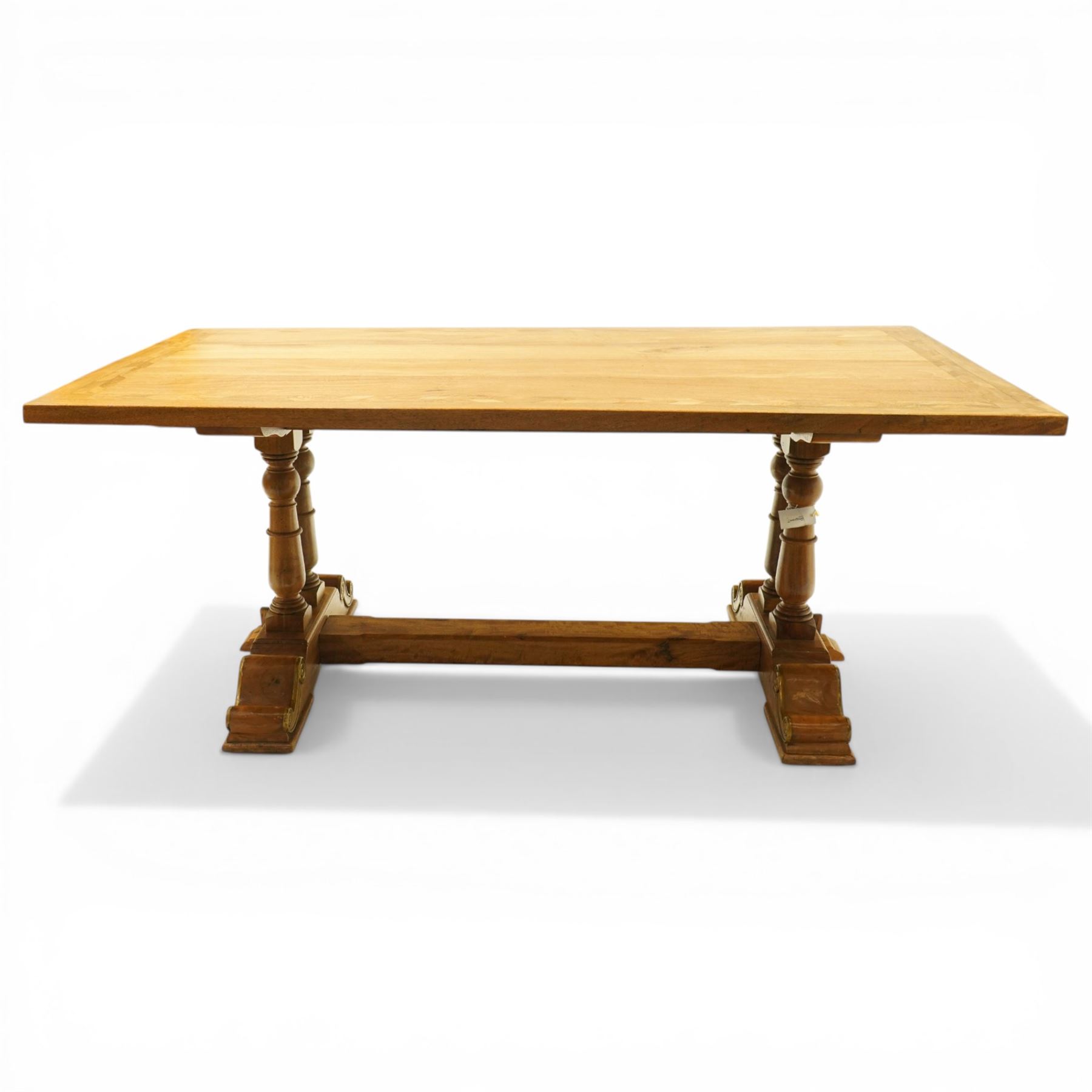 Baker Furniture - 'Baluster' range mango wood dining suite, comprising a refectory dining table raised on twin pillars with scrolled bases, with six chairs including two carvers, with gilt mounts and neutral upholstery