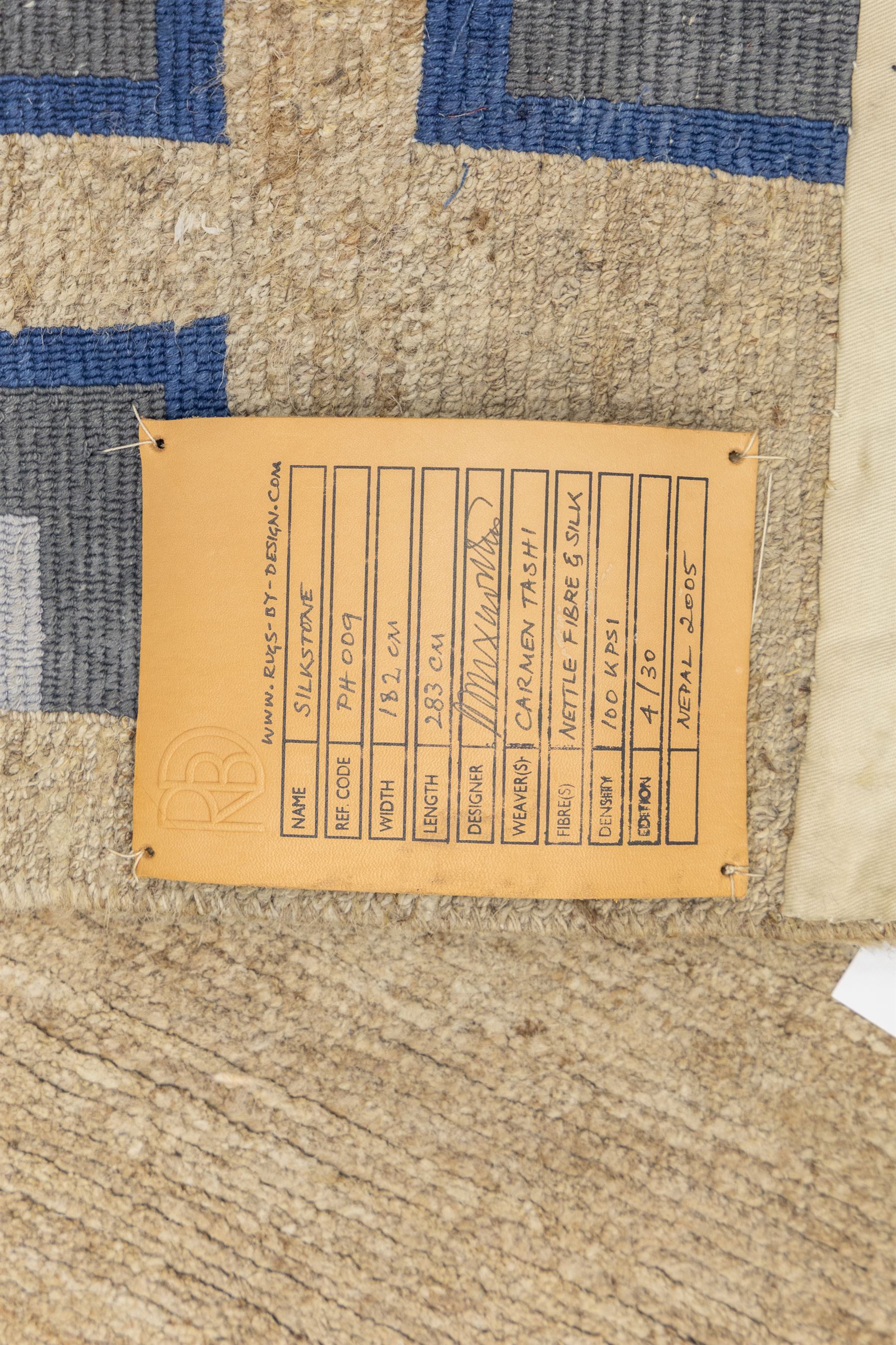 Rugs by Design - ‘Silk Stone’ Nepalese thick pile wool rug, with plain textured camel ground and geometric border detail in blue, grey and dark tones to all four sides