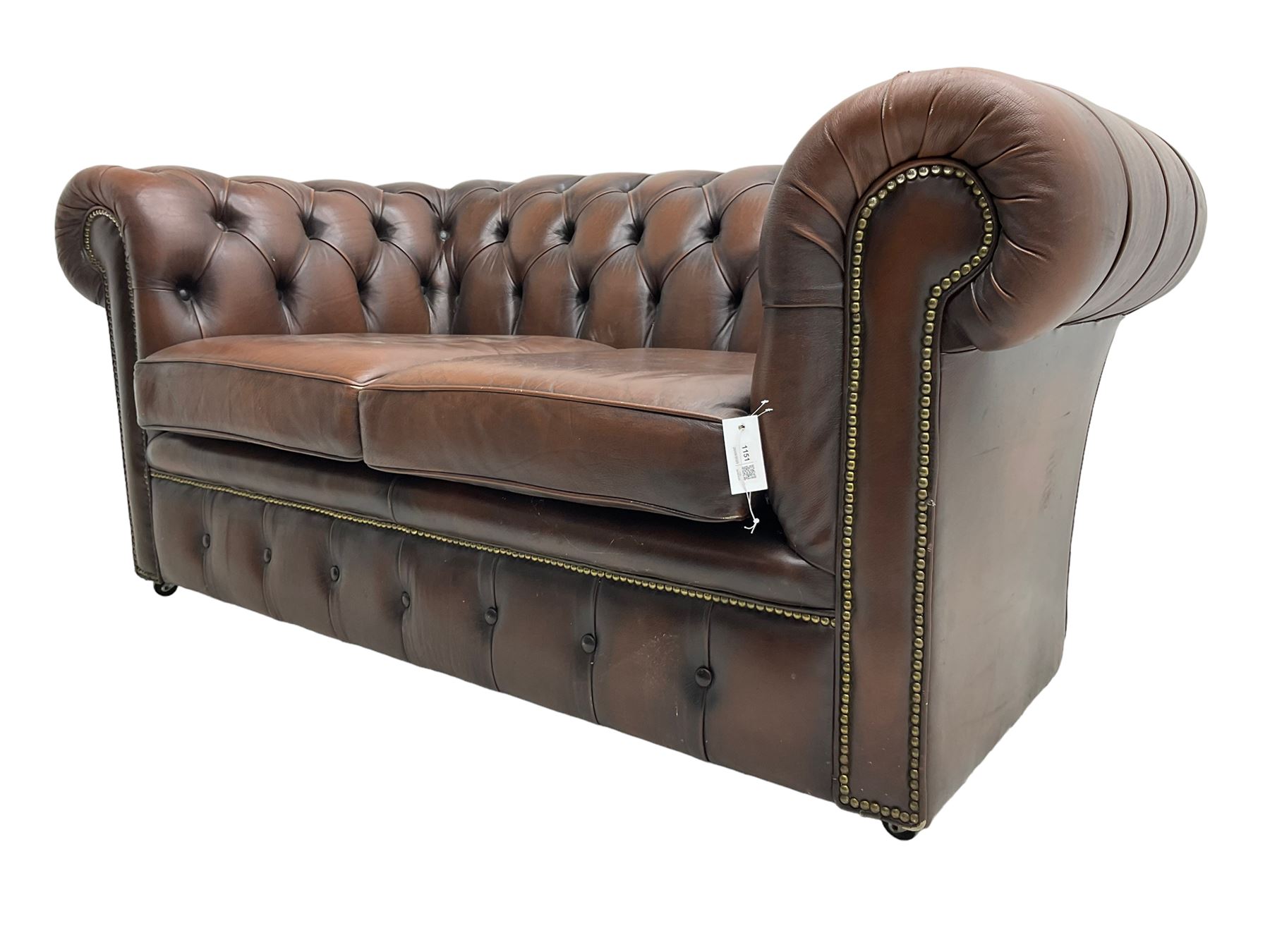 Chesterfield two seat sofa, upholstered in brown buttoned leather
