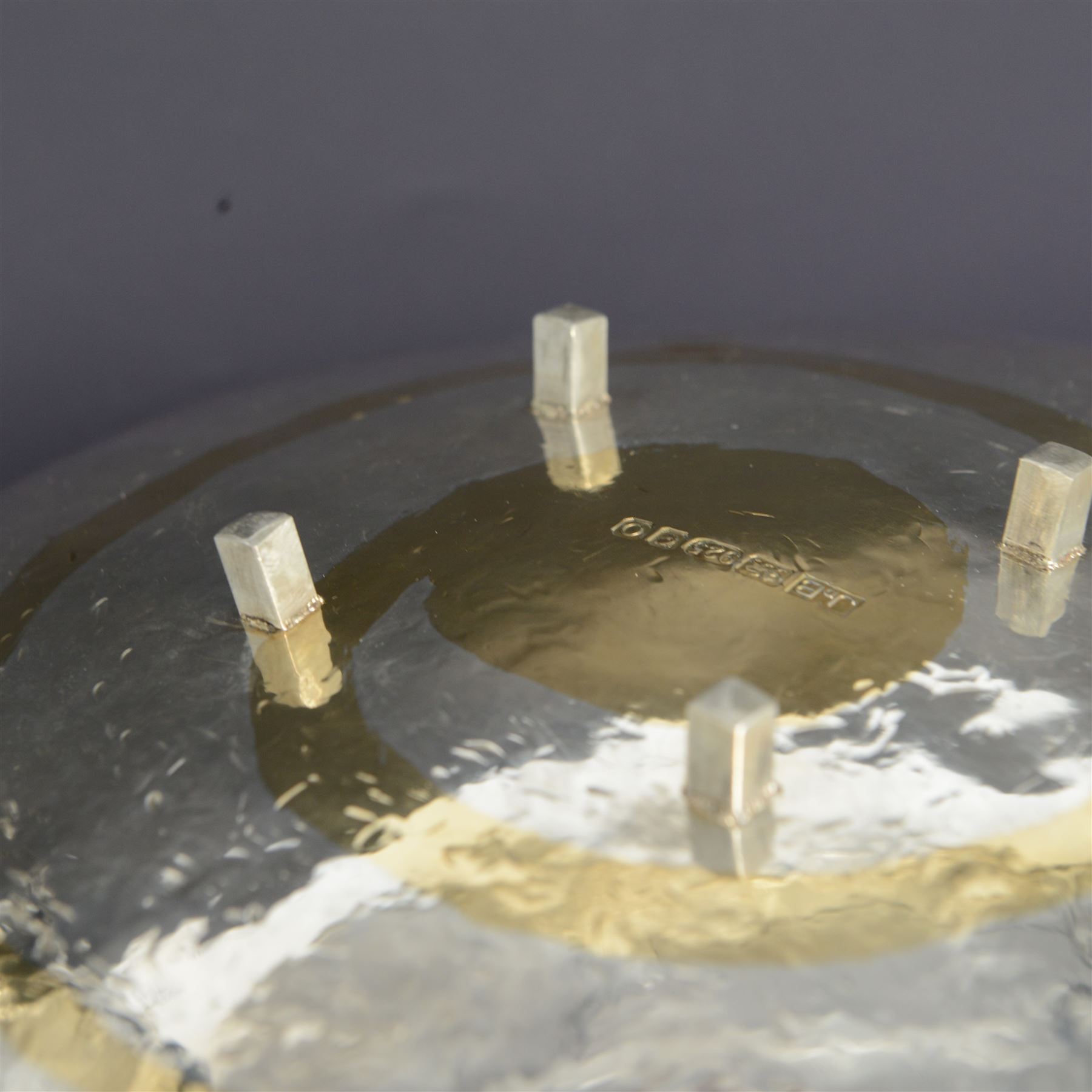 Modern silver bowl, of square concave form, with gilt interior and gilt spiral decoration to underside, with planished decoration throughout, upon four column feet, hallmarked Jonathan Braganza, London 2013, H5cm, W18cm