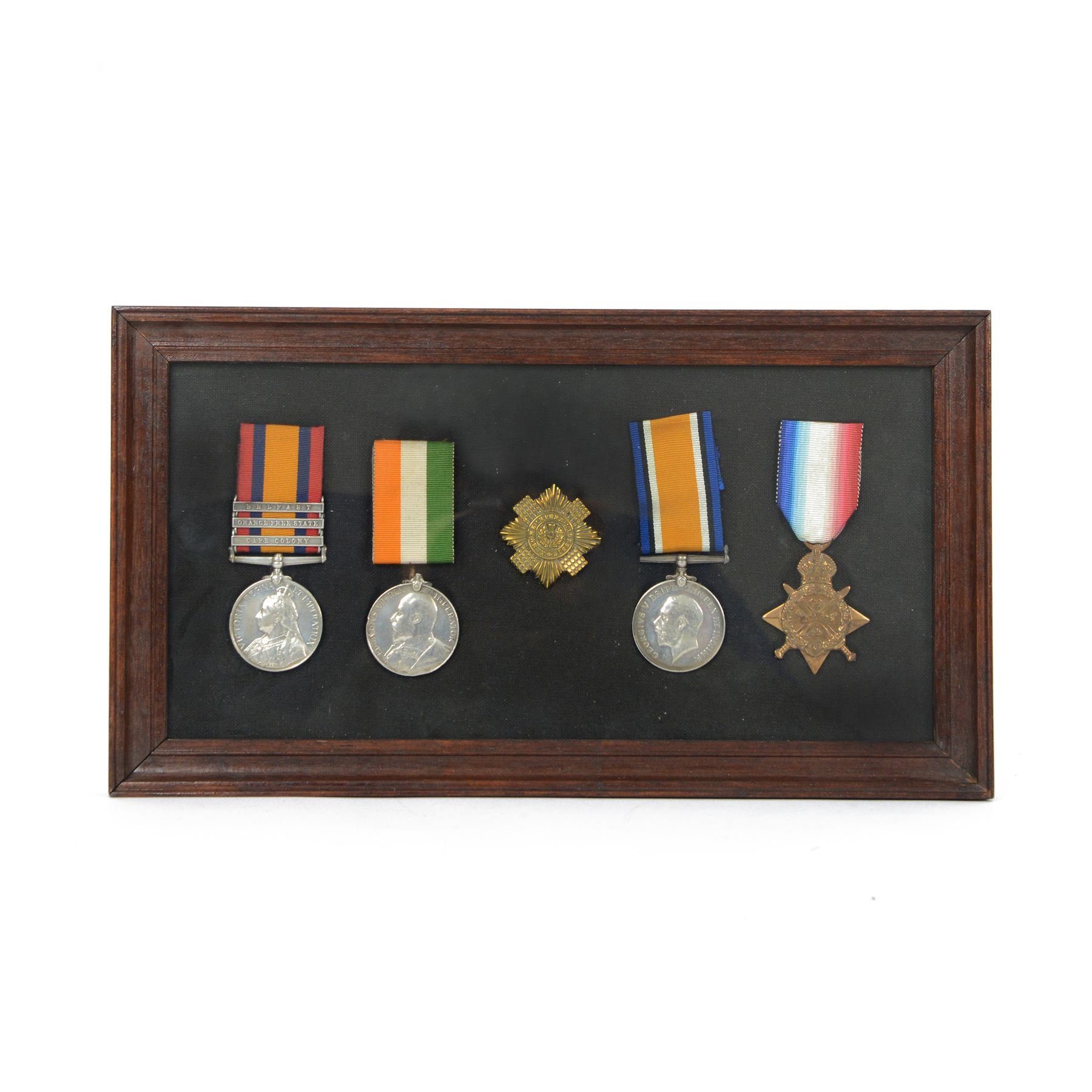 Victorian Queens South Africa Medal with Belfast Orange Free State and Cape Colony clasps, Kings South Africa medal, awarded to 72 Pte W Wilson Scots Gds and WWI war medal and 1914 star, awarded to 9335 Pte W Neilson S Gds, all framed with Scots Guard Beret badge to the centre 