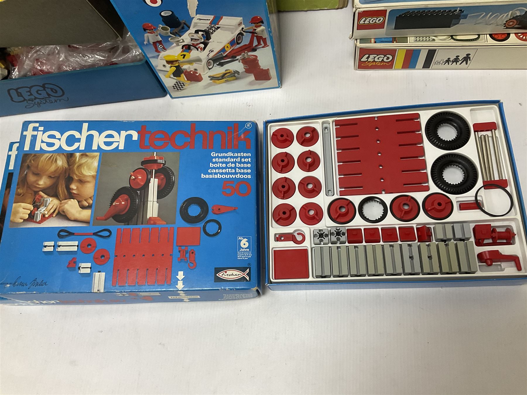 Fischer Technik/Lego/Playmobil - thirteen model building sets comprising eight Fischer Technik sets 50, 50/1, 50v, 50/2, 50+mot1 and two 50S, 50/1 add-on pack, with spare parts packs 01, 03, 05, two 22 and 30; two Lego sets comprising C107 and Lego Systems 103, part-set 870 and 970; Playmobil no.3520 set; four boxes of loose lego, various instruction manuals and a scrapbook 